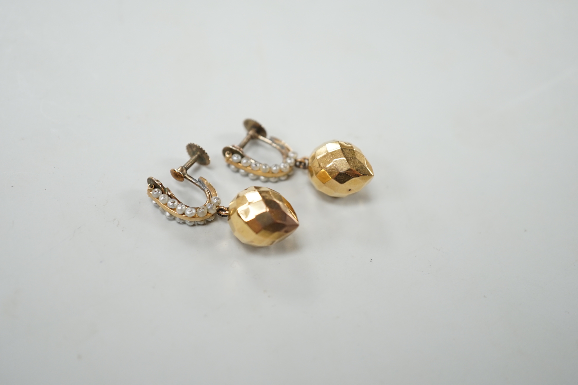 A pair of Victorian yellow metal and seed pearl 'facetted' drop ear clips, overall 34mm, gross weight 5.2 grams.